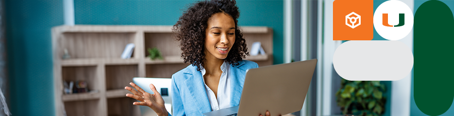 A Woman seems to be talking over a computer screen and smiling 