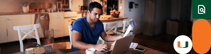 Preparing for the A+ Certification Exams while sitting in his home with a papaer and an open computer