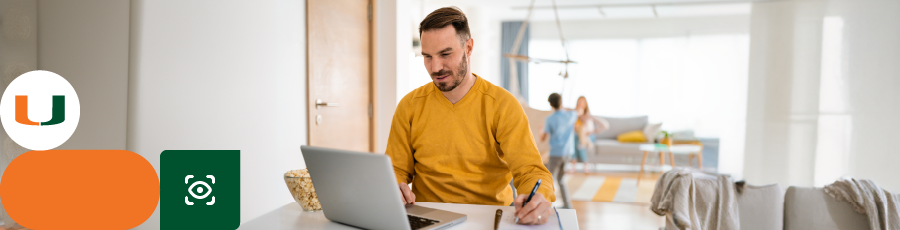 with his computer open, reading and learning for The OSCP Exam for Miami Residents